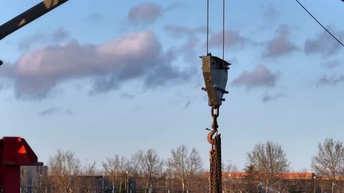 Chains hanging on a hook that hangs from a crane, aerial view
