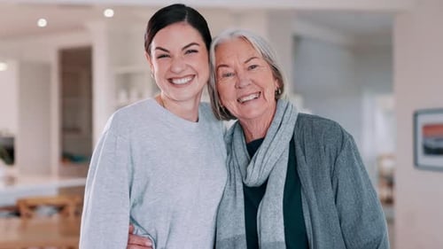 Smiling Women Embracing Affectionately Indoors