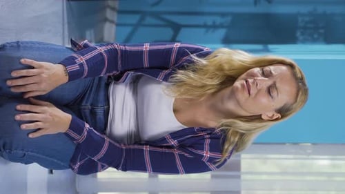 Distressed Woman Sitting on the Floor, Looking Sad