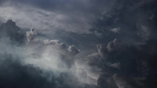 Dramatic Clouds Against Dark Blue Sky