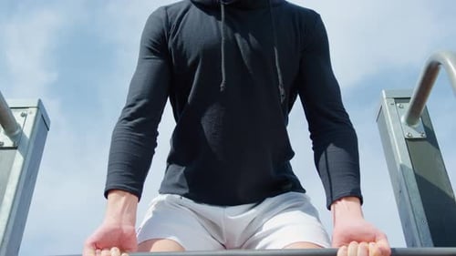 Close-up of A Young Man Lifting Weights in an Outdoor Gym