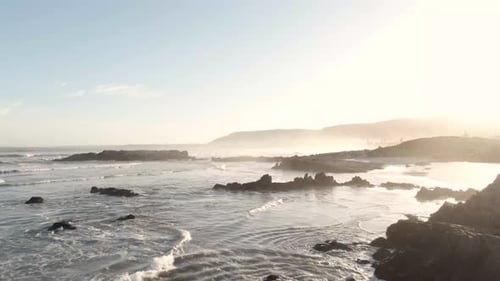 Drone Flight Over Wavy Seascape With Outcrops And Fog In Hermanus, South Africa On A Sunny Summer Da