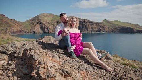 Couple Enjoying Romantic Moments on a Cliff Overlooking the Ocean