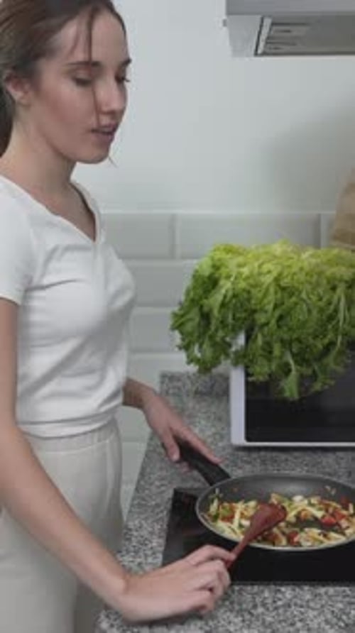 Woman Cooking Stir Fry at Home in Kitchen