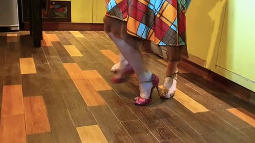 Two Women Dancing Together in Kitchen at Home
