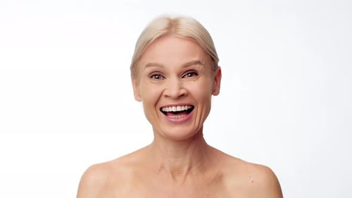 Mature Woman Enjoying Skin Care Pampering in a Bright Setting