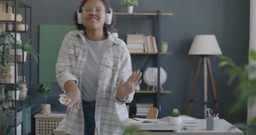 Happy Woman Dancing at Home Wearing Headphones
