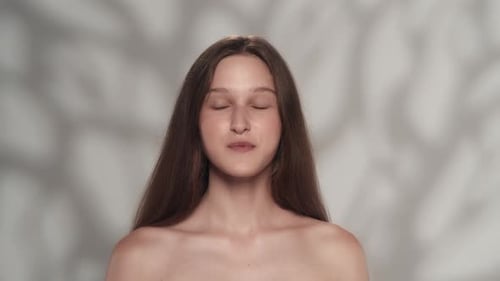 Woman with Long Brown Hair Smiling at Camera