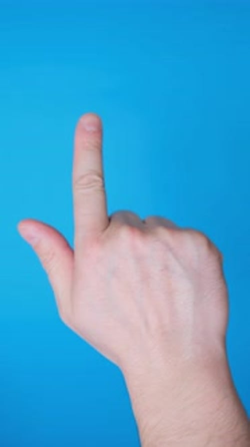 A Man Makes a Thumbs Up Gesture on a Blue Screen Vertical Video