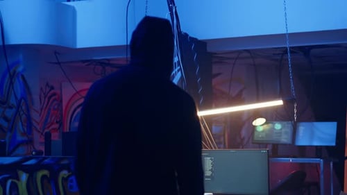 Hooded Hacker Arriving in Hidden Underground Shelter