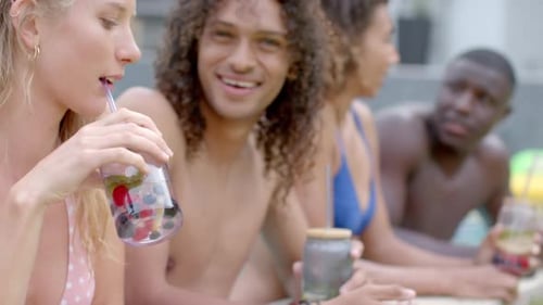 Friends Relaxing Poolside Enjoying Refreshing Drinks