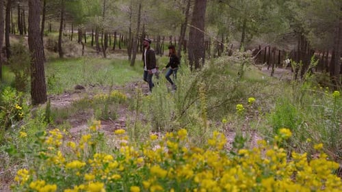 Family strolls through Mediterranean bush in springtime