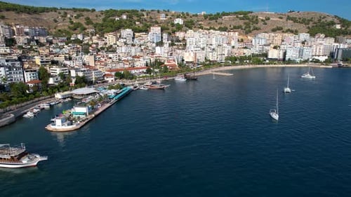 Splendid Blue Bay of Coastal Saranda: Boats, Promenade, and the Serene Beauty of a Calm City Holiday