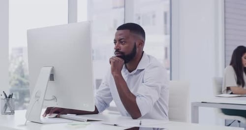 4k video footage of a businessman working on his computer while sitting in a modern office