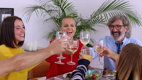 Family Celebrates Together with a Toast at Dinner