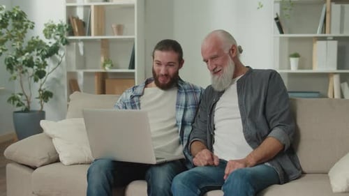 Young Volunteer Teaches Senior How to Use a Tablet Bridging Generation Gap