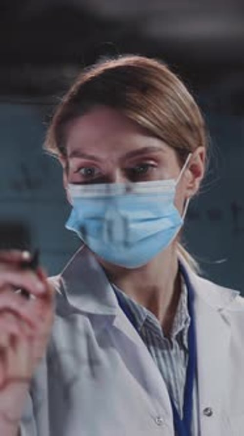 Woman in Lab Coat Drawing Scientific Diagram