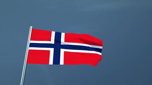 Waving Norwegian Flag on Pole Against Blue Sky