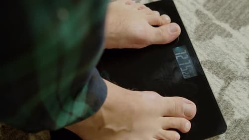 Feet on Scale Showing Kilogram Weight