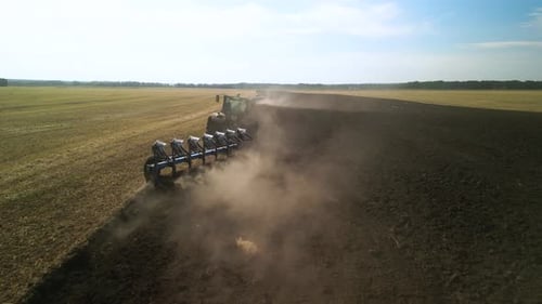 Tractors plowing the field in Ukraine