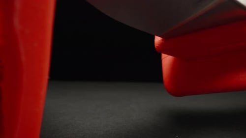 Sharp knife for an electrician with red handles. Dolly slider extreme close-up. Laowa Probe