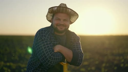 Joyful Farm Worker Leaning on Shovel After Hard Working in Field Portrait Smiling Middleaged Man in