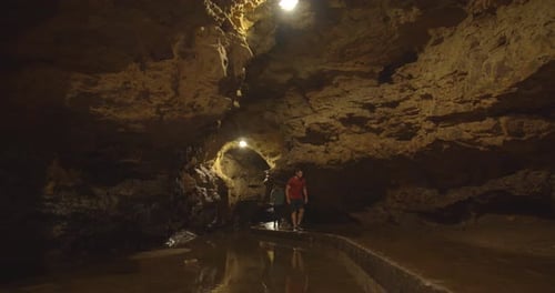 People exploring the deep dark maquoketa caves in Iowa