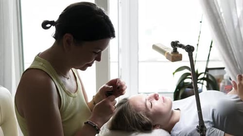 Woman Applying Cosmetics on Eyebrows Indoors