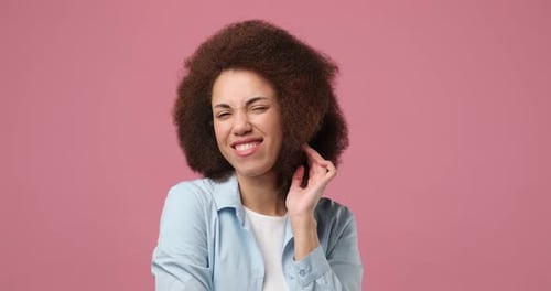 Woman Smiling with Curly Hair in Studio