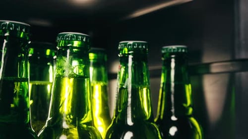 Row of Beer Bottles in Fridge Shop or Hotel Cold Lager Craft German Beer or Cider Shop Supermarket