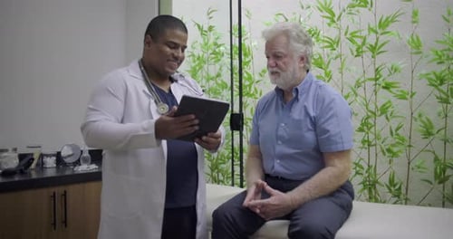 Doctor Consults Senior Patient in Modern Medical Office