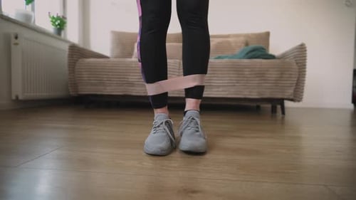Girl Doing Fitness Exercises With Rubber Resistance Bend