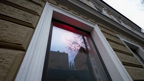 Red EURO Logo on a Reflective Window of a Modern Financial Blockchain Office