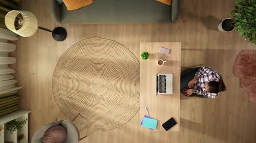 Top View Capturing a Woman Having a Videocall Talking to Somebody on a Laptop in Her Home Office