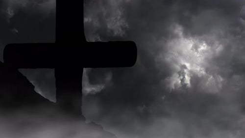 Silhouetted Cross Against Swirling Storm Clouds