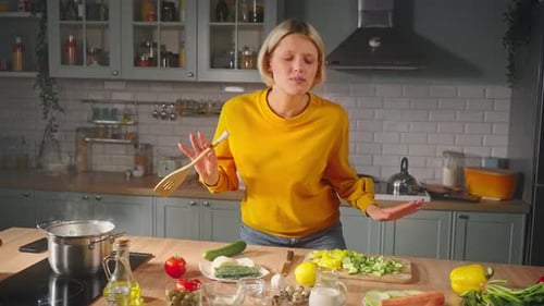 Woman Singing and Dancing while Cooking in Kitchen