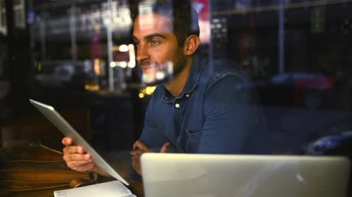 Tablet, thinking and remote work with a man in a coffee shop for research as a freelance employee