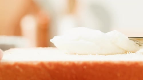 Spreading Cream Cheese on Bread Slice with Knife