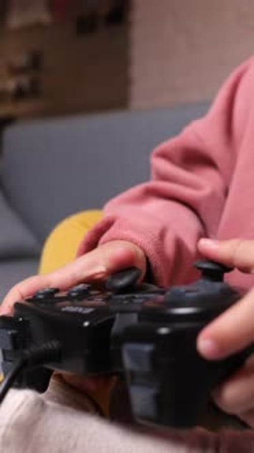 Little Girl Plays Video Games with Controller