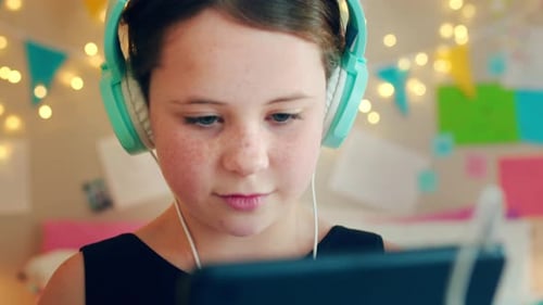 Headphones, tablet and girl in bedroom for online education, e learning