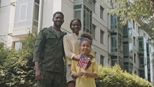 Portrait of Joyous Black Soldier with Wife and Daughter Outdoors on Street