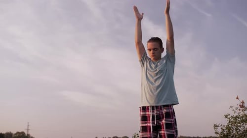 Young Man Stretching in the Beautiful Evening Sunlight