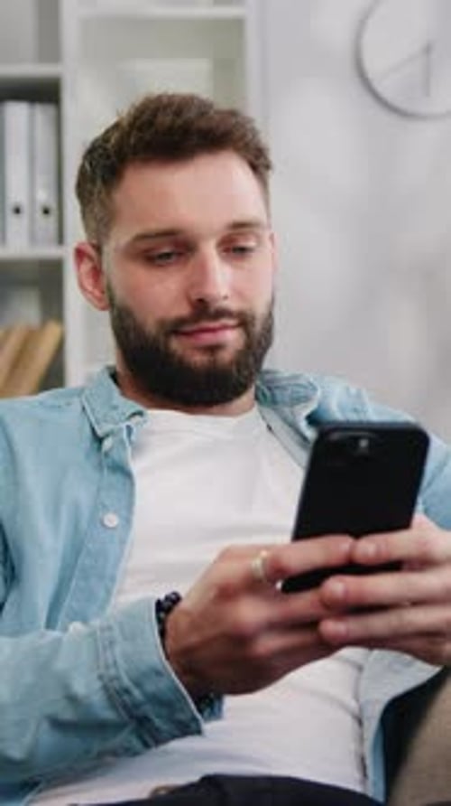 Bearded Man Using Cell Phone at Home