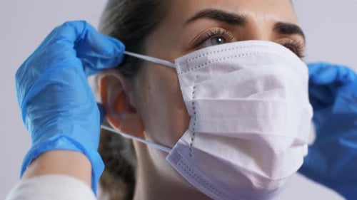 Woman Wearing Face Mask and Blue Surgical Gloves