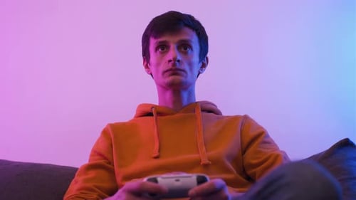 Young Adult Gamer on Couch with Controller