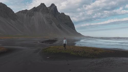 Black Sand Beach with Hvalnes Lighthouse and Walking Figures