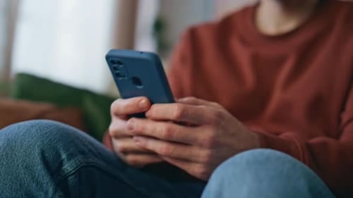Closeup Man Hands Messaging Smartphone at Home Close Up Cheerful Guy Laughing