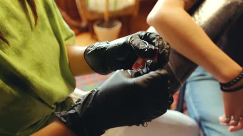 Hands of Female Tattoo Artist Preparing Needle for Tattooing