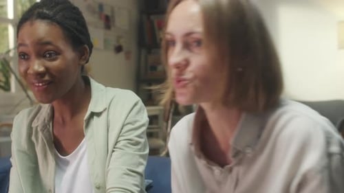 Women Enjoying Video Games Together at Home