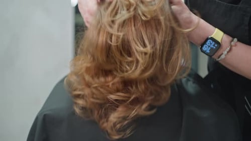 Client Getting Hairstyle Touched Up at the Salon